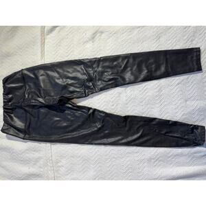 black faux leather leggings by La Classe Couture.